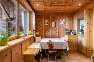 a dining room with a table and a window at Feldererhof Apt Hochstein in Santa Maddalena