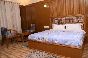 um quarto com uma cama, uma mesa e cadeiras em Vasant Corbett Resort em Ramnagar