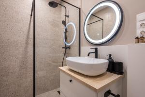 a bathroom with a sink and a shower at KL35- Boutique Apartments, Best Location. By BQA in Budapest