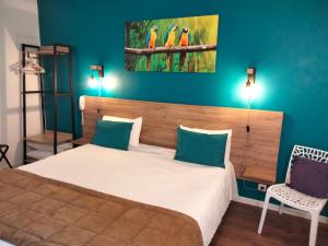 - une chambre avec un lit avec deux oiseaux sur le mur dans l'établissement Hotel Au Sans Souci, à Chinon