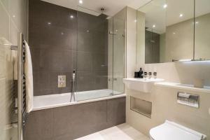 a bathroom with a shower and a toilet and a sink at Luxury Flat Croydon in Croydon