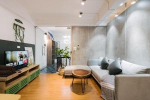 a living room with a couch and a tv at KemKayVilla w 5BR_ Bathtub_RooftopViews_30s to HoanKiem Lake in Hanoi