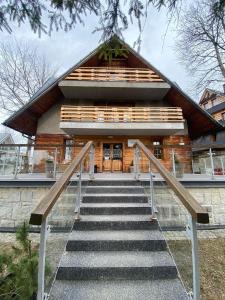 a house with stairs leading up to it at Willa Sienkiewiczówka in Zakopane