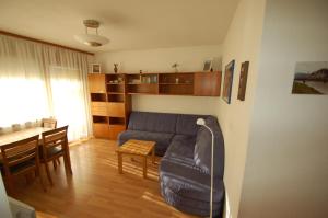 a living room with a couch and a table at Familienappartement Talblick in Saalbach Hinterglemm