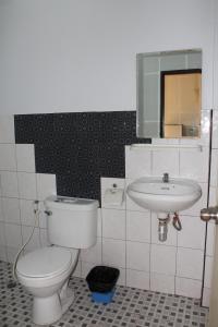 a bathroom with a toilet and a sink at OYO 75420 Howto Hotel in Chiang Mai