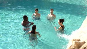 a group of people swimming in the water at Balneario de Alicún de las Torres in Villanueva de las Torres