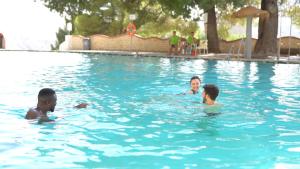 a group of people swimming in a swimming pool at Balneario de Alicún de las Torres in Villanueva de las Torres