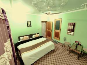 a bedroom with a large bed and a table at Sheesha Residency in Srinagar