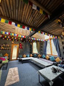 a room with a bed and flags on the ceiling at Sunshine Cafe & Cottage Riverside in Shoja +37 photos