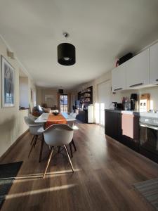 a kitchen with a table and chairs in a room at Suite a Folgaria in Folgaria