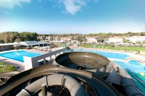 a slide at a resort with a swimming pool at Tuscany By The Sea in Tirrenia