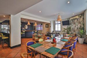 a dining room with a table and chairs at Thistle Hotel in Pietermaritzburg