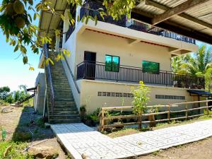 a house with stairs leading up to it at Felcordz Nature Farm & Resort 