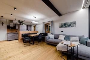a living room with a couch and a table at Heselehof Waldchalets in Langenwang