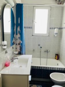 a bathroom with a sink and a tub and a toilet at Sea voyage in Nafplio +29 photos