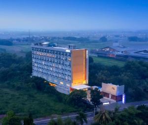 a large building with a lit up facade at ASTON Mojokerto Hotel & Conference Center in Mojokerto