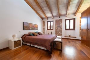 a bedroom with a large bed and wooden floors at Can Puça -Sa Pobla- in Sa Pobla