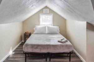 a bedroom with a large bed in a attic at Fabulous House near Airpt/DwTN/UofR in Rochester