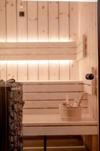 a sauna with a bucket and a light on top at Heselehof Waldchalets in Langenwang