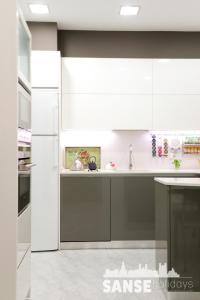 a kitchen with white cabinets and a refrigerator at Apartamento Usan in San Sebastián
