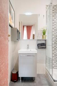 a bathroom with a white sink and a shower at Pantheon Caravaggio's House in Rome