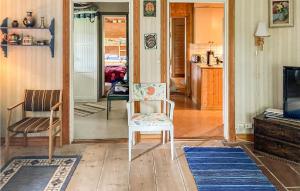 a living room with a chair and a television at Awesome Home In Lima With Sauna And 2 Bedrooms in Lima