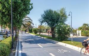 a street with trees and a bike lane at Trilo Sup in Alba Adriatica +11 photos