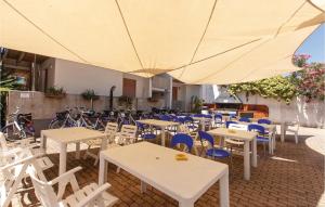 a group of tables and chairs with a large umbrella at Trilo Sup in Alba Adriatica