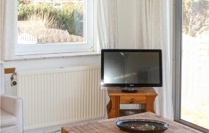 a television sitting on a table in a living room at Pimpernel2 in Bergen aan Zee +6 photos