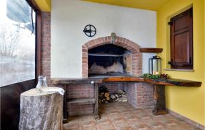 a brick fireplace in a room with a table at Amazing Home In Adamovec With Sauna in Adamovec +28 photos