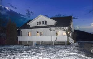 a large white house with snow on the ground at 3 Bedroom Nice Home In Lunde in Lunde