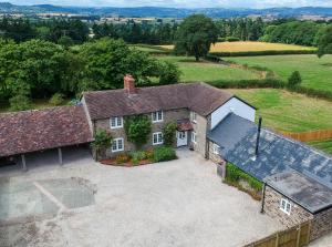 an aerial view of a house with a driveway at Roundton House in Chirbury