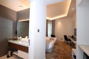a hotel room with a bed and a bathroom at eStay Hotel in Dubai