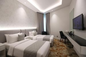 TV a/nebo společenská místnost v ubytování eStay Hotel