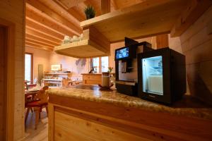 a television sitting on top of a counter in a cabin at TerrazzaPaganella in Terlago