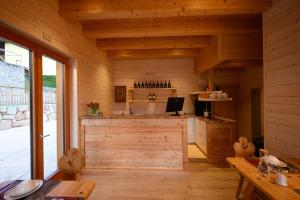 a kitchen in a wooden cabin with a counter at TerrazzaPaganella in Terlago