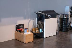 a coffee maker and a box on a counter at Centrally Located Light-filled Studio w Parking in Auckland