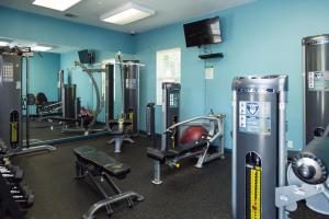 a gym with several tread machines in a room at Newly Updated Condo At Waikoloa Colony Villas in Waikoloa