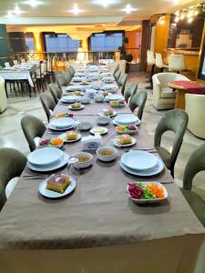 a long table with plates of food on it at SPOR HOTEL in Ankara