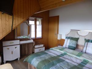 a bedroom with a bed and a staircase at Alpenblick Ferenberg Bern in Stettlen
