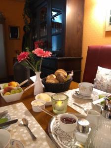 a table with a bowl of bread and a plate of food at Fata Morgana in Cochem