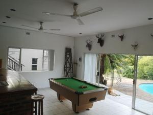 a room with a pool table and a swimming pool at Villa Incognito in Clansthal