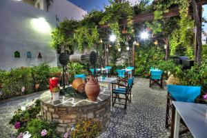 a patio with a table and chairs and plants at Eleni Dream Village in Parikia
