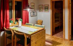 a kitchen with a wooden table and chairs at 2 Bedroom Nice Home In Idre in Idre