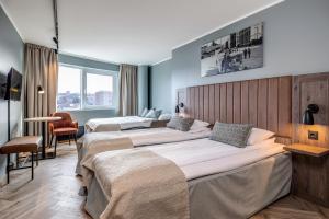 um quarto de hotel com três camas num quarto em Anker Hotel em Oslo