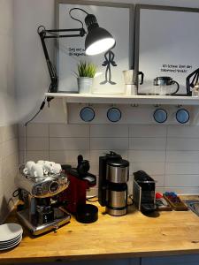 a kitchen counter with a coffee maker and a light at Ferienwohnung "Harzliebe" in Gernrode - Harz