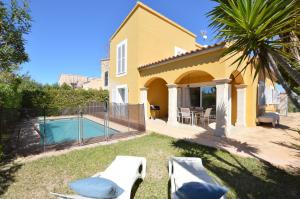 a backyard with a house and a swimming pool at Villa Sa Ràpita / Es Trenc in Campos