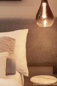 a bed with a white pillow and a lamp at Anaya Living - Colombo 03 in Colombo