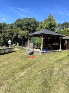 a gazebo with a red frisbee in the grass at Open plan area sleeping up to 2 adults & 2 children in Bideford