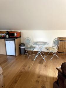 a kitchen with a table and chairs in a room at Open plan area sleeping up to 2 adults & 2 children in Bideford